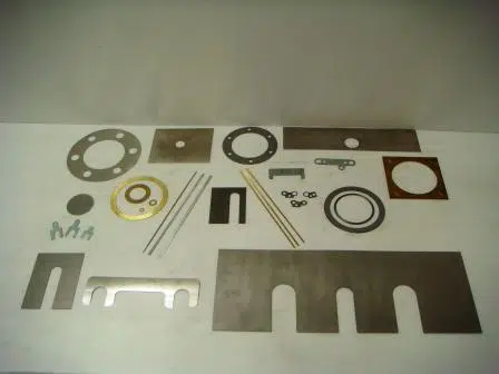 Assortment of custom-cut metal shims, washers and slotted shims