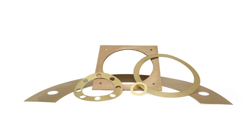 Custom-cut brass shims in ring and flange shapes