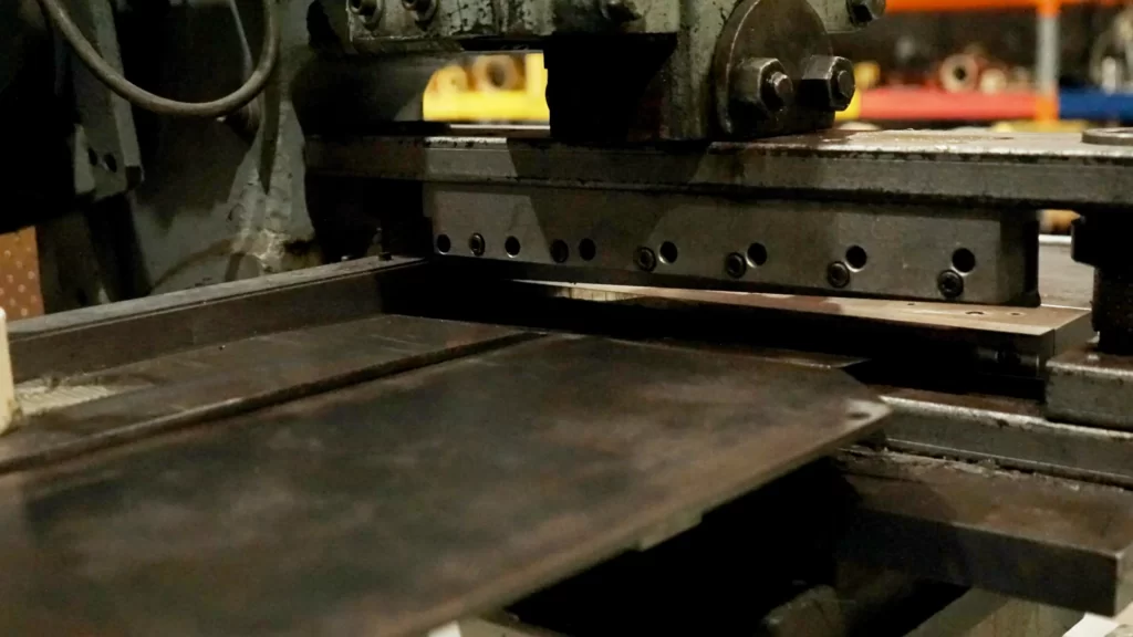 Metal shim sheet being cut on a guillotine