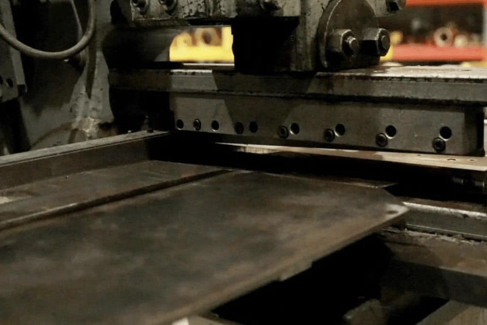 Metal sheet positioned on a guillotine shear for cutting